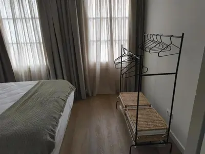 a bedroom with a bed and two windows at AGR Apartamento Villapanés in Jerez de la Frontera