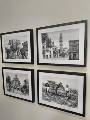 a group of pictures hanging on a wall at AGR Apartamento Villapanés in Jerez de la Frontera