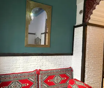 a mirror on a wall next to a bench with a mirror at Apartamento Plaza del Cabildo - Sanlúcar Centro in Sanlúcar de Barrameda