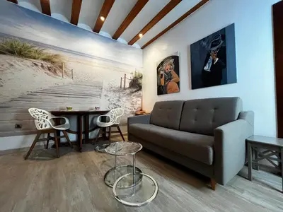 a living room with a couch and a table at El patio de la Pepa Grupo Ac Gestion in Cádiz
