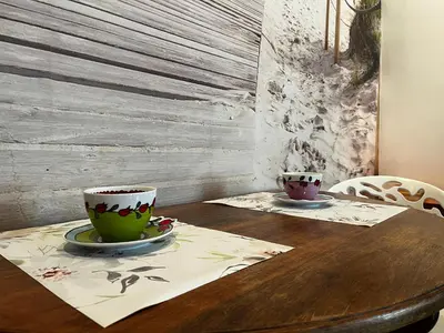 two cups of coffee sitting on a wooden table at El patio de la Pepa Grupo Ac Gestion in Cádiz