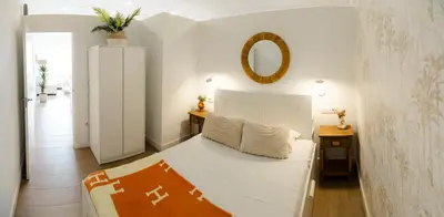 a bedroom with a bed and a mirror on the wall at Urban Vistahermosa in El Puerto de Santa María