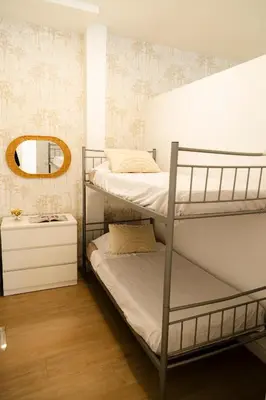 a bedroom with two bunk beds and a mirror at Urban Vistahermosa in El Puerto de Santa María