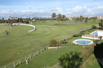 an aerial view of a golf course with a pool at Apartamento Costa Ballena Playa y Golf in Cádiz
