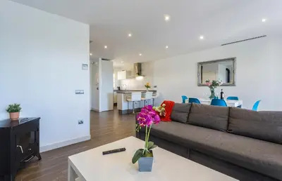 a living room with a couch and a table with flowers at 