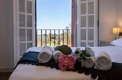 a bedroom with a bed with towels and a window at 