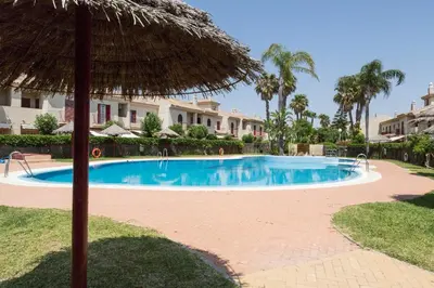 a swimming pool with an umbrella and some houses at 