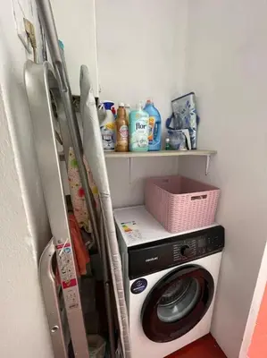 a kitchen with a washing machine and a refrigerator at Arenas de la Victoria by Gades Gestión in Cádiz