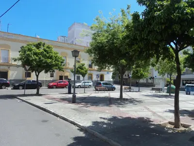 a street with benches and trees in front of a building at Apartamento Centro Jerez Carbón in Jerez de la Frontera
