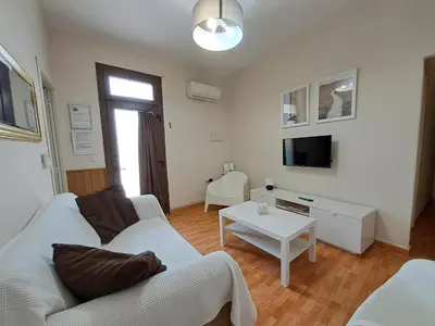 a living room with a white couch and a table at Apartamento Centro Jerez Carbón in Jerez de la Frontera