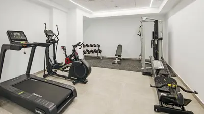 a gym with cardio equipment in a room at Sercotel Cruz Del Mar in Chipiona