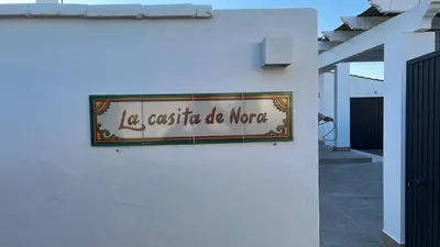 a sign on a wall that reads la casita do more at La Casita de Nora in Conil de la Frontera