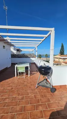a grill and a table on a patio at El Baluarte by Sanlúcar Housing in Sanlúcar de Barrameda
