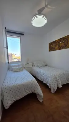 an office with a desk with a laptop and a staircase at El Baluarte by Sanlúcar Housing in Sanlúcar de Barrameda