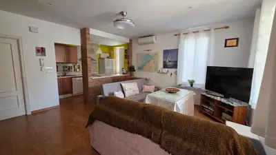 a living room with a couch and a table at El Baluarte by Sanlúcar Housing in Sanlúcar de Barrameda