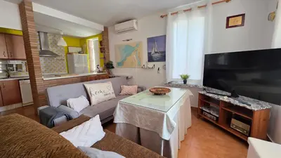 a bedroom with a bed and a flat screen tv at El Baluarte by Sanlúcar Housing in Sanlúcar de Barrameda