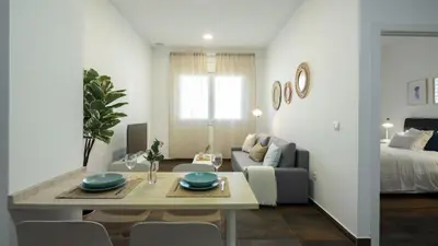 a living room with a table and a couch at Antiguo Balneario in Cádiz