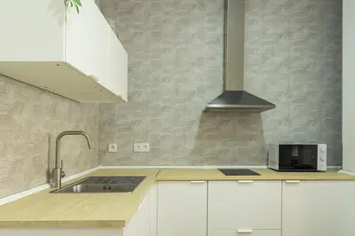 a kitchen with a sink and a stove at Antiguo Balneario in Cádiz