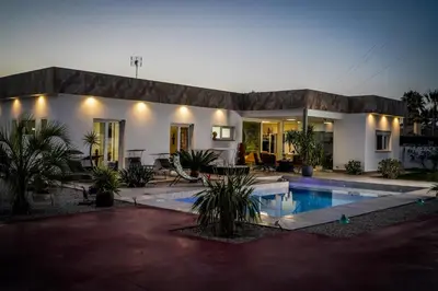 a house with a swimming pool in front of it at Spacious villa with pool in Chiclana de la Frontera in Chiclana de la Frontera