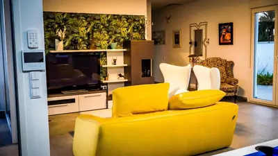 a bedroom with a bed with red pillows and a desk at Spacious villa with pool in Chiclana de la Frontera in Chiclana de la Frontera