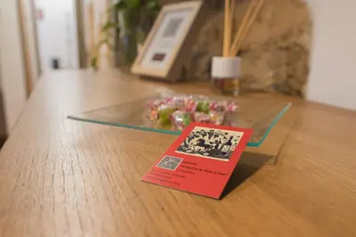 a book sitting on top of a table with a glass table sidx sidx at El Rincón de Pepa y Juan in Jerez de la Frontera