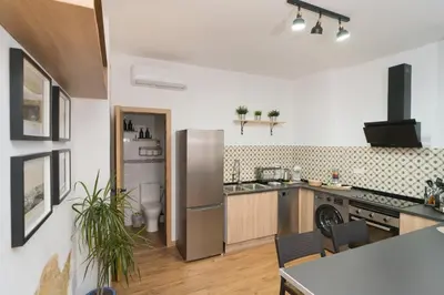a kitchen with a stainless steel refrigerator freezer at El Rincón de Pepa y Juan in Jerez de la Frontera