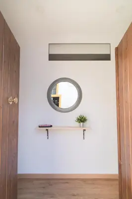 a mirror on a wall next to a door at El Rincón de Pepa y Juan in Jerez de la Frontera
