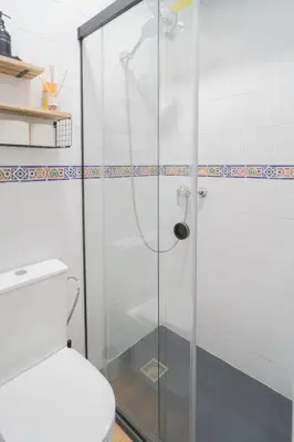 a glass shower in a bathroom with a toilet at El Rincón de Pepa y Juan in Jerez de la Frontera