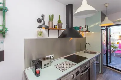 a kitchen with a sink and a counter top at Wehostcostaluz EL NIDO GADITANO in Cádiz