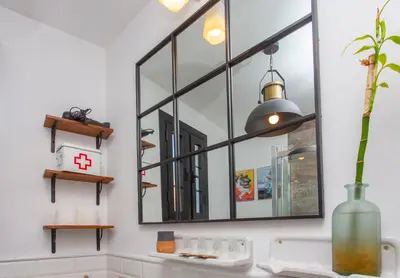 a large mirror on a wall in a bathroom at Wehostcostaluz EL NIDO GADITANO in Cádiz