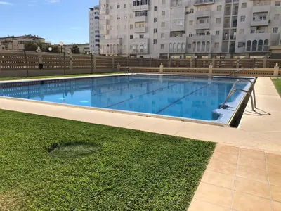 an empty swimming pool in front of a building at Vistas al mar primera linea playa Valdelagrana in El Puerto de Santa María