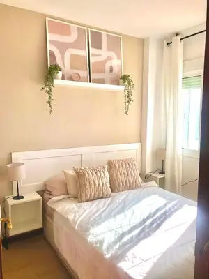 a bedroom with a bed with two pillows on it at Vistas al mar primera linea playa Valdelagrana in El Puerto de Santa María