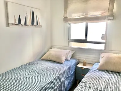 a bedroom with two beds and a window with sailboats at ALOJA Diseño acogedor 3 habitaciones in El Puerto de Santa María