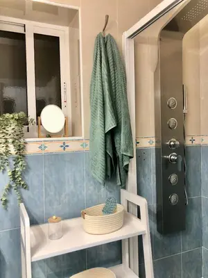 a bathroom with a sink and a shower with a towel at ALOJA Diseño acogedor 3 habitaciones in El Puerto de Santa María
