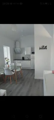 a kitchen with a table and chairs in a room at Apartamento Eluan in Arcos de la Frontera