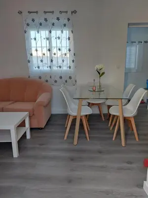 a living room with a table and chairs and a couch at Apartamento Eluan in Arcos de la Frontera