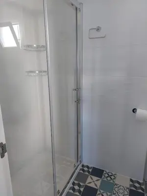 a shower with a glass door in a bathroom at Apartamento Eluan in Arcos de la Frontera