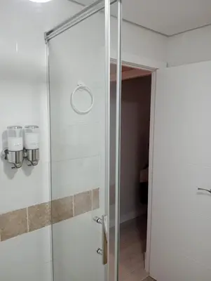 a glass shower in a bathroom with at Apartamento Buhaira Free Parking in Cádiz