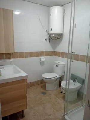 a bathroom with a toilet and a sink at Apartamento Buhaira Free Parking in Cádiz