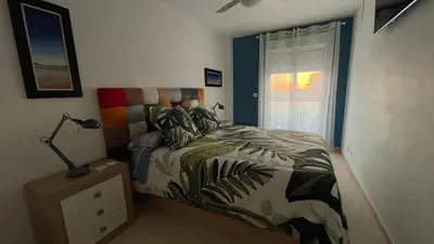 a bedroom with a bed and a window at Casa Salina in Chiclana de la Frontera