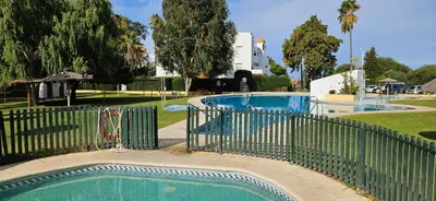 a swimming pool with a fence around it at Casa Salina in Chiclana de la Frontera