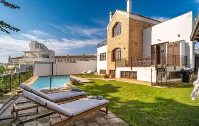 a backyard with a swimming pool and a house at Beautiful Home In Conil De La Frontera in Conil de la Frontera
