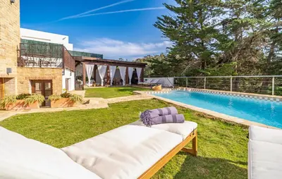 a backyard with a swimming pool and a couch at Beautiful Home In Conil De La Frontera in Conil de la Frontera