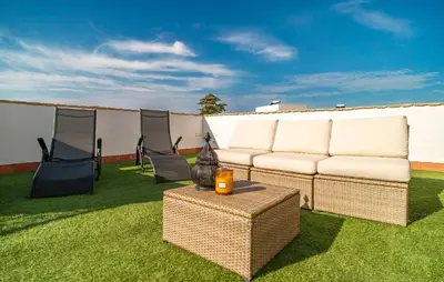 a couch and two chairs and a table on the grass at Beautiful Home In Conil De La Frontera in Conil de la Frontera