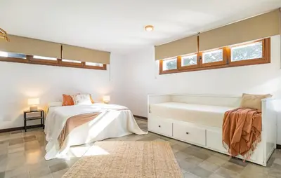 a bedroom with two beds and two windows at Beautiful Home In Conil De La Frontera in Conil de la Frontera