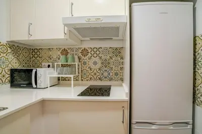 a kitchen with a refrigerator and a microwave at Casa con encanto - Wifi, aire acondicionado in Puerto Real