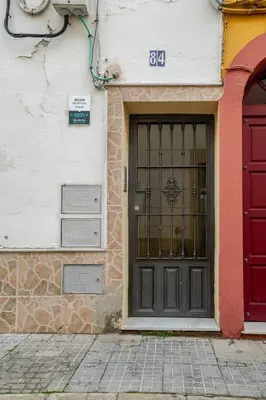 a door of a building with a red door at Casa con encanto - Wifi, aire acondicionado in Puerto Real