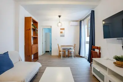 a living room with a couch and a table at Casa con encanto - Wifi, aire acondicionado in Puerto Real