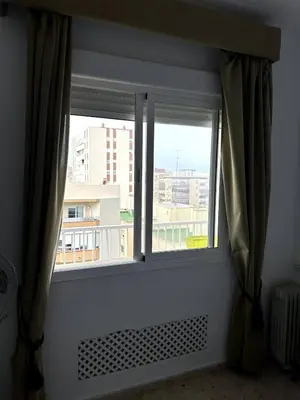 a window with a view of a city at Paraíso Frente al Mar en Cádiz in Cádiz