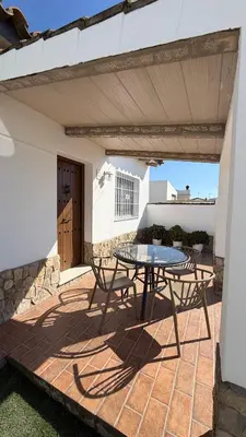 a bedroom with a bed in a room with a fan at Villa Ojos Del Océano in Cádiz